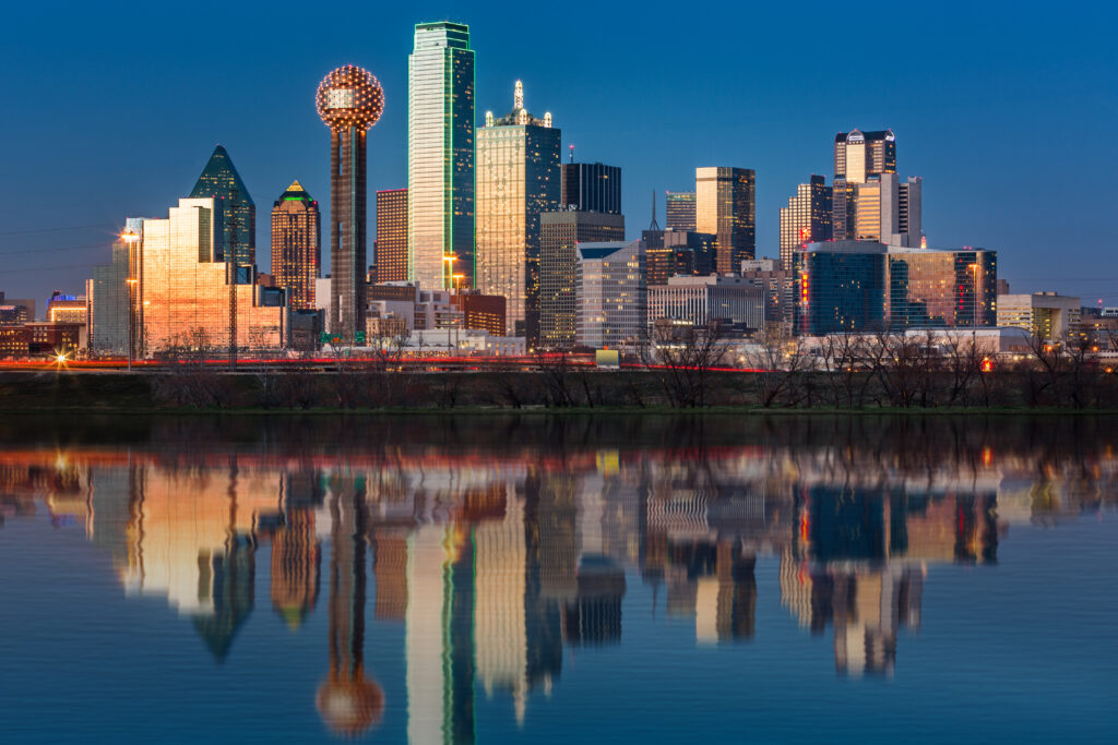 The Dallas skyline reflected in the Trinity River at sunset